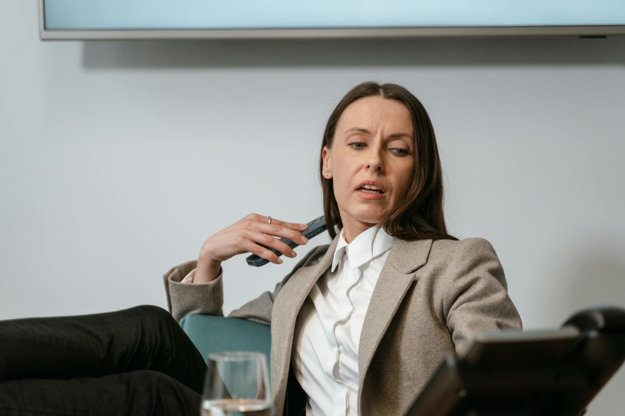 Confident businesswoman engaging in a corporate meeting indoors.